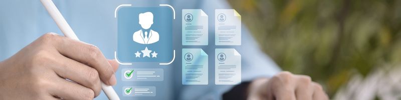 Graphic showing a representation of a person's employment profile with four documents attached and two references with green checkmarks superimposed over an image of a person using a tablet