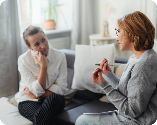 A behavioral case manager counsels a patient who looks tearful