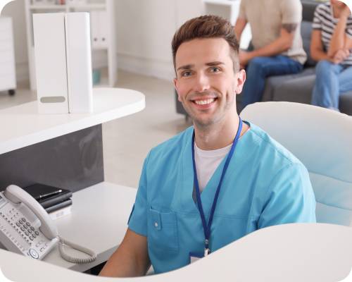 A patient access representative smiles at the camera in the waiting room of a facility