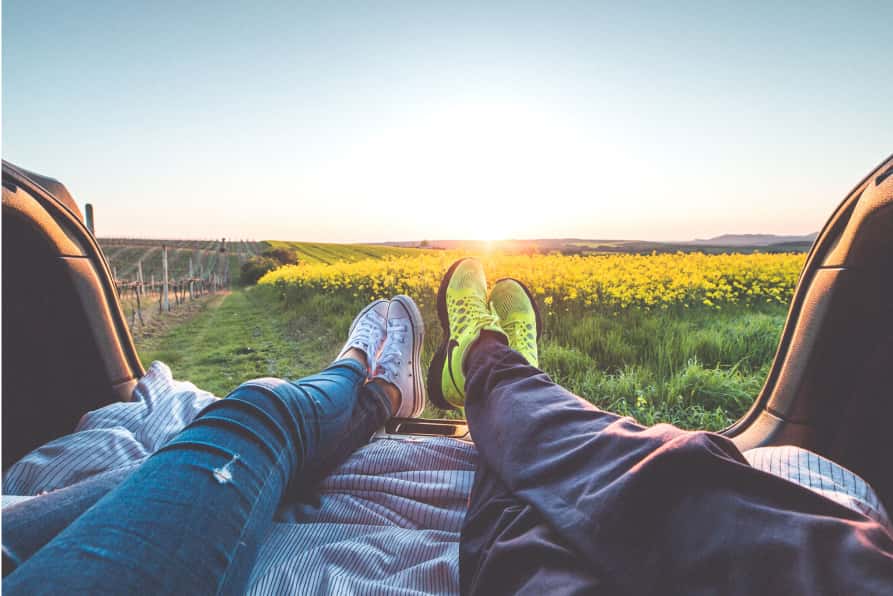 2 people relaxing at a field