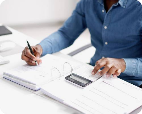A healthcare accounting clerk uses a calculator to confirm data