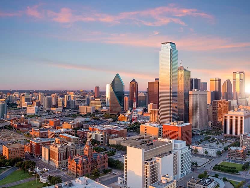 Image showing a cityscape with illuminated skyscrapers at night in Texas.