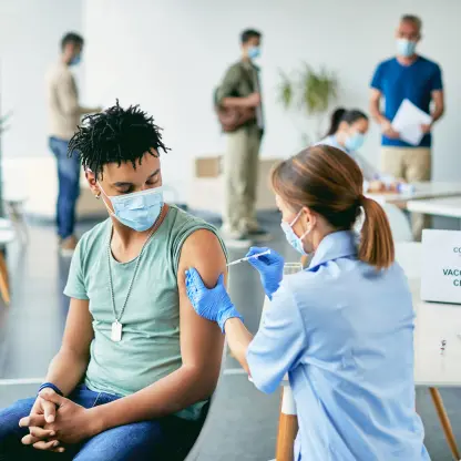 Travel nurse injecting a vaccination into a patient