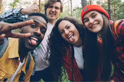 Diverse group of young friends taking a selfie while hiking