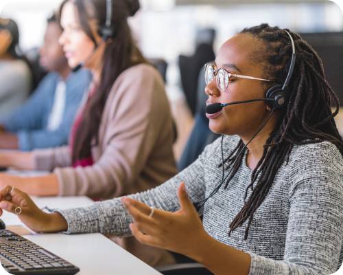 An insurance verification specialist takes a phone call over her headset