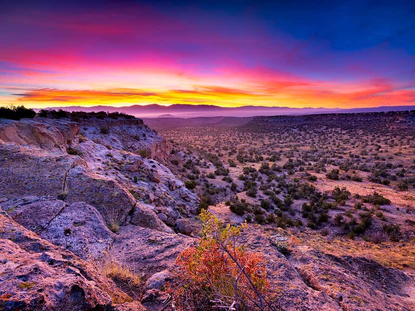 Image showing a dramatic sunset over layered rock formations in Arizona. 