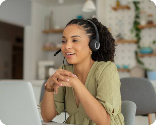 A surgery scheduler talks on the phone in front of her computer