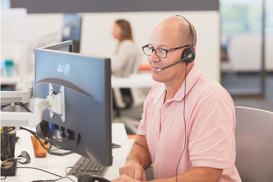 Male Trustaff worker enjoying work at the office