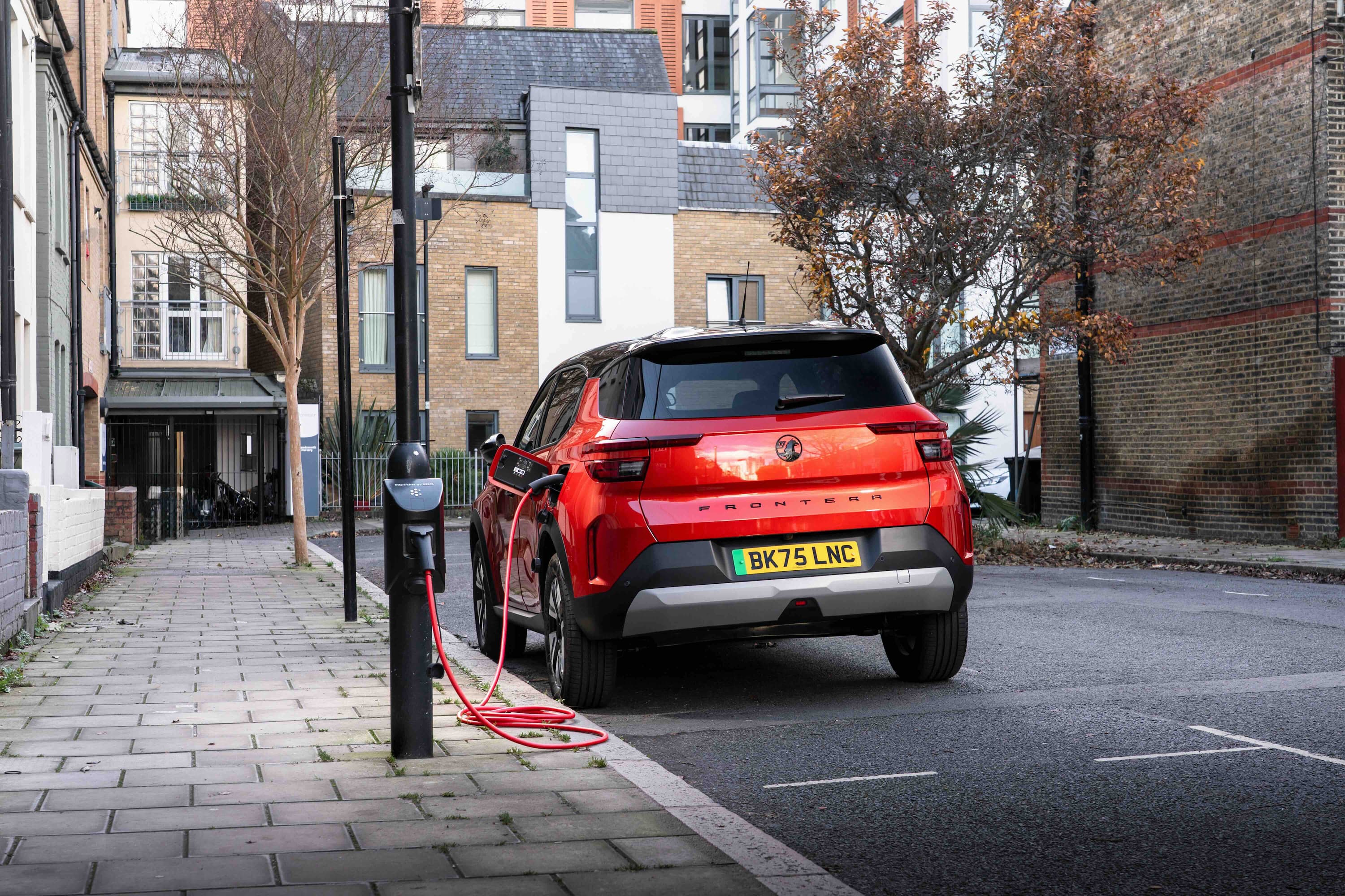 Red small SUV using the char.gy charger 