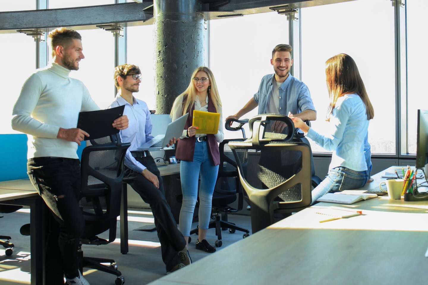 A group of people talking in an office