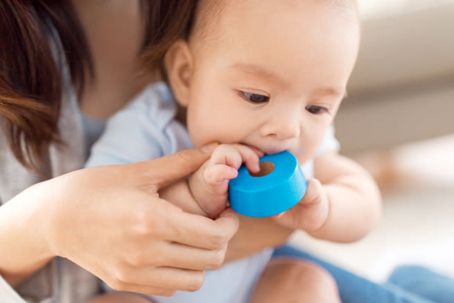 Baby with toy in mouth