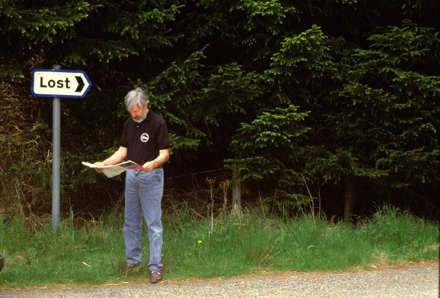 Man with map, lost in the forest