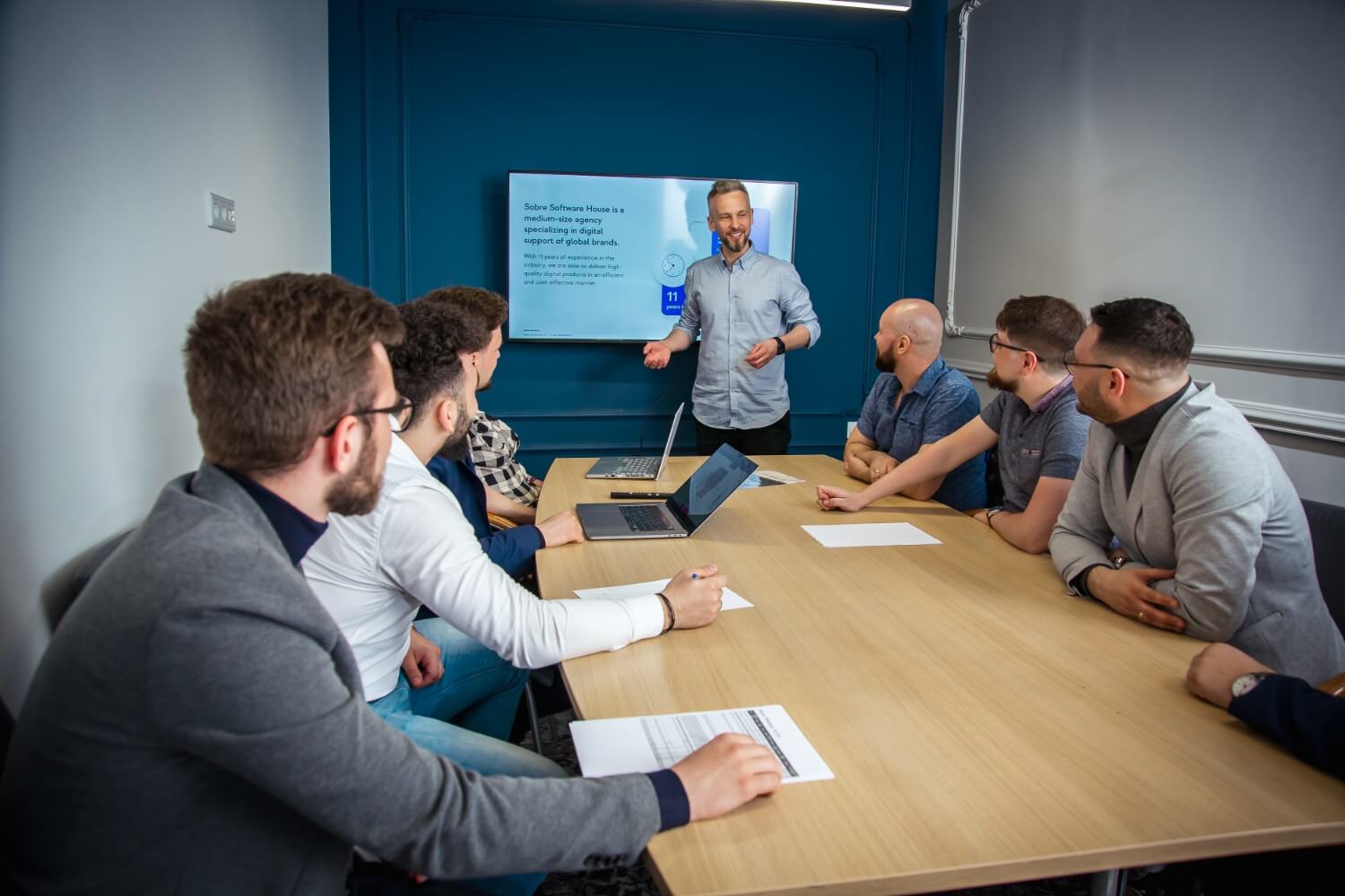a man giving presentation in conference room