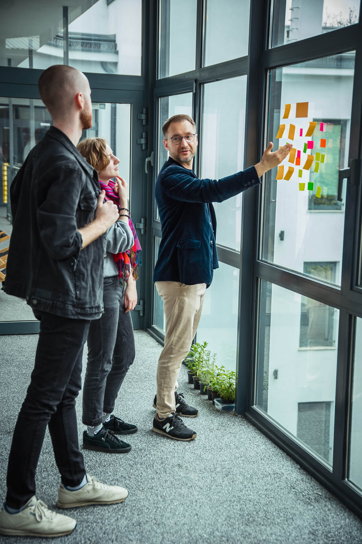ux designer pointing at sticky notes