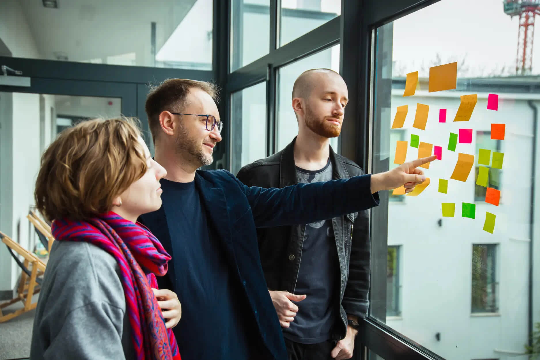 ux designer pointing at sticky notes