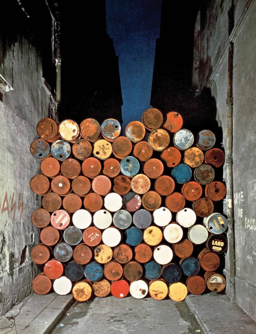 Christo   jeanne claude  wall of oil barrels     the iron curtain  rue visconti  paris  1961 62