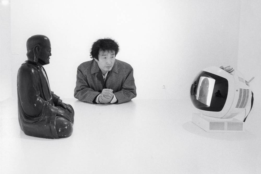  Nam June Paik and his Buddha TV , Museum of Modern Art, New York, Photograph by Eric Kroll, 1977  