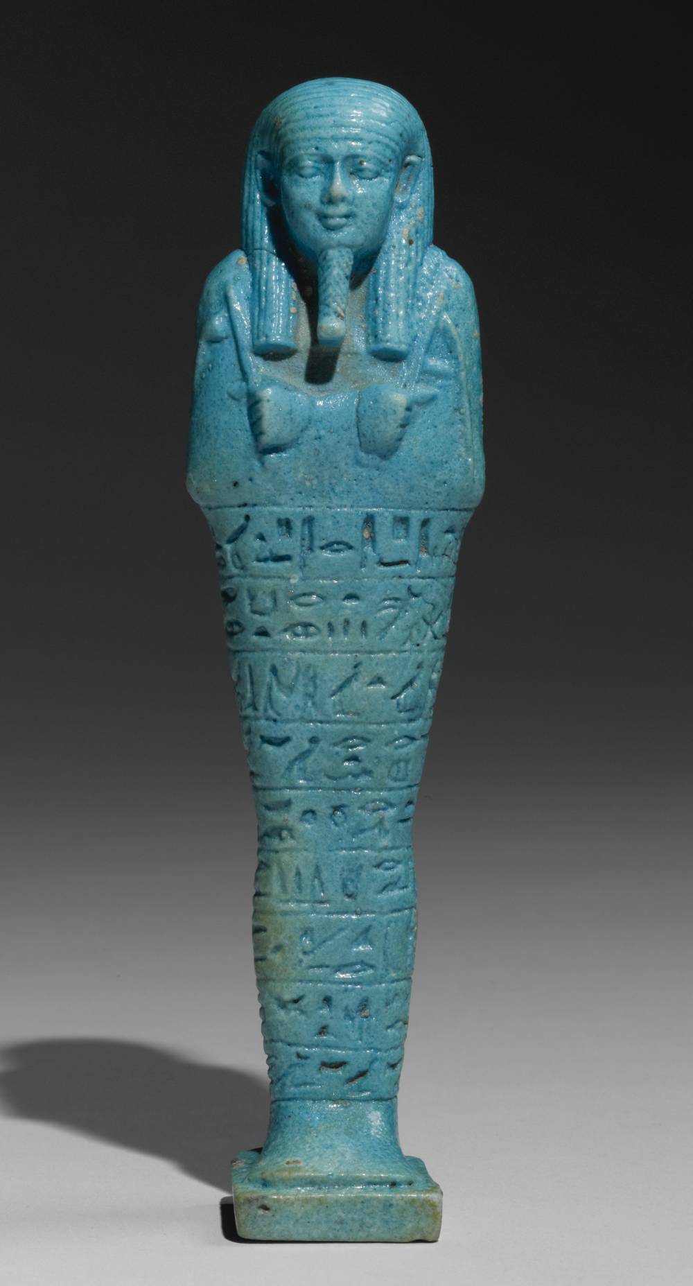 An egyptian bright blue faience ushabti of psamtik  god s father  born to seba rekhyet  570 526 b.c