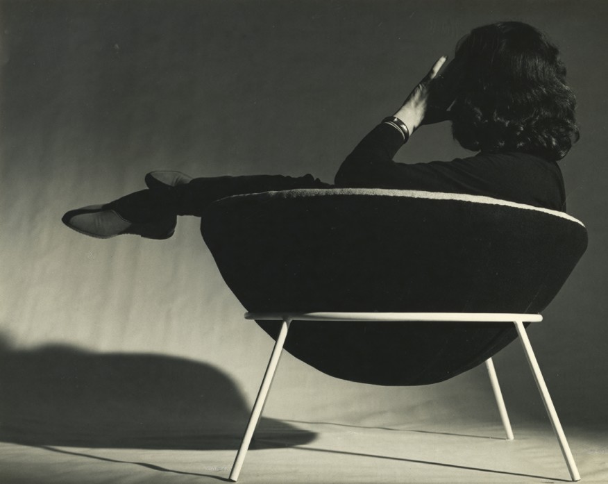 Lina bo bardi lounging in her iconic bowl chair.