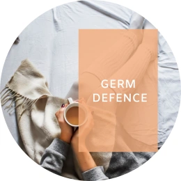 Caption reads: Germ defence. In the background a person sick in bed holds a hot drink.