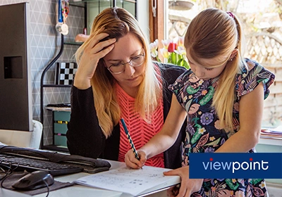 Mother and child look at homework together