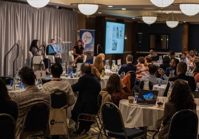 Attendees watch speakers at the MAXIS GBN Innovation Event at The Argonaut Hotel in San Francisco in 2022.