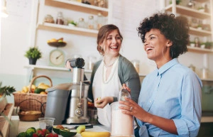 Two women making smoothies