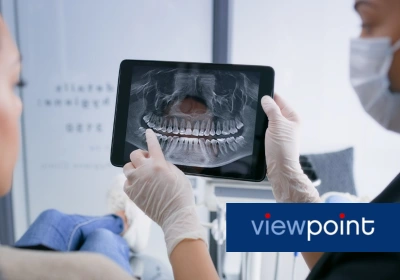 Image of dentist and patient looking at an x-ray of teeth, with a Viewpoint logo.
