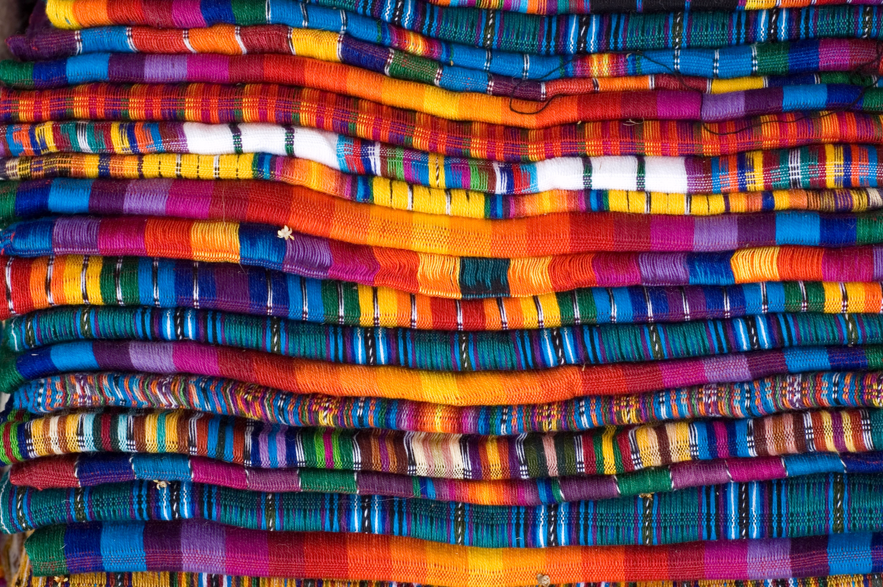 An image with many colourful textiles 