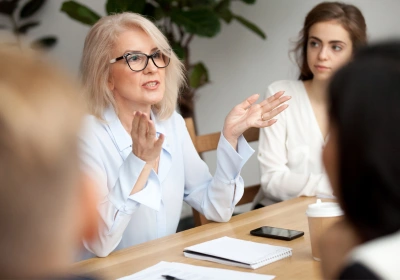 Woman meeting grey hair talking with hands, menopause