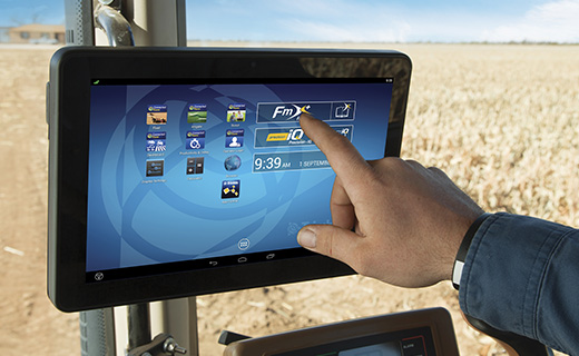 A farmer navigates the launch screen of Trimble's TMX-2050 display.