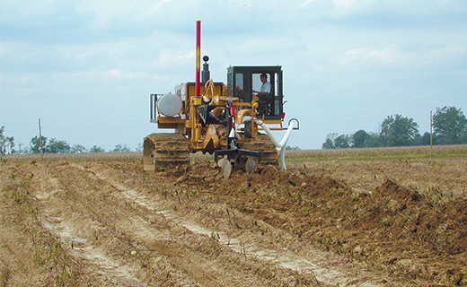 A farmer or earthworks contractor uses Trimble's AG GCS300/400 grade control system for a water management project.