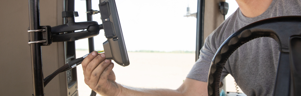 A farmer installs a new Trimble display in his tractor.
