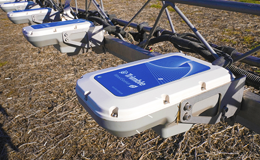 A close-up photograph of Trimble's WeedSeeker 2 spot spray system in the field.