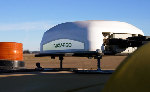 The NAV-860 guidance controller mounted to the roof of a tractor.