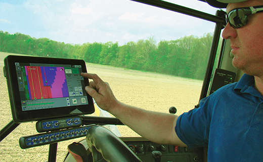A farmer conducts variable rate application using Trimble's TMX-2050 display.