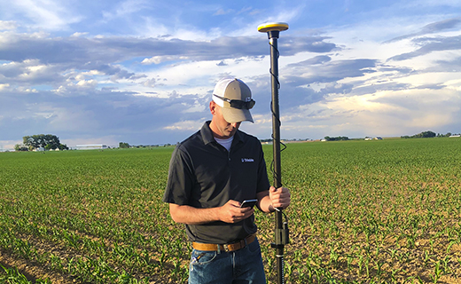 A farmer conducts a survey using the Trimble WM-Survey II app.