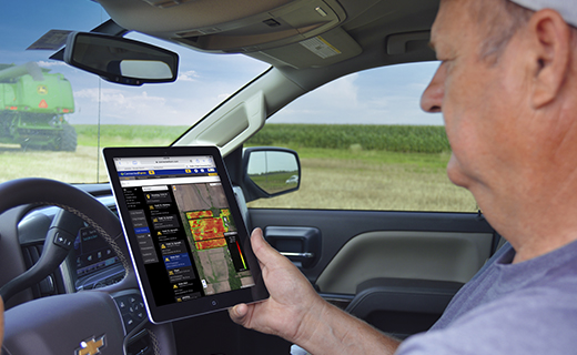 A farmer accesses his Trimble Ag Software data on a tablet in his truck.