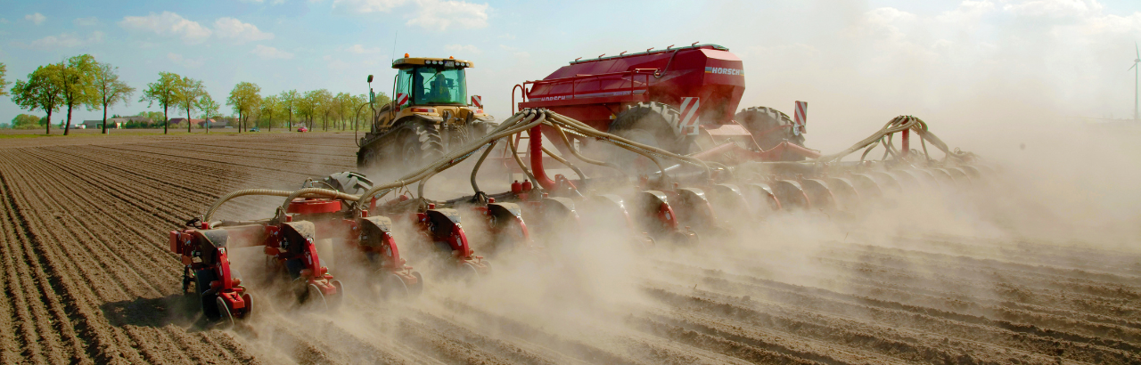 A farmer plants a field.