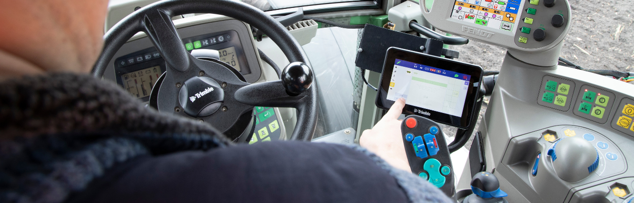 A farmer uses Trimble's GFX-350 display.