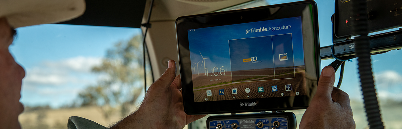 a farmer looking at a PTx Trimble display