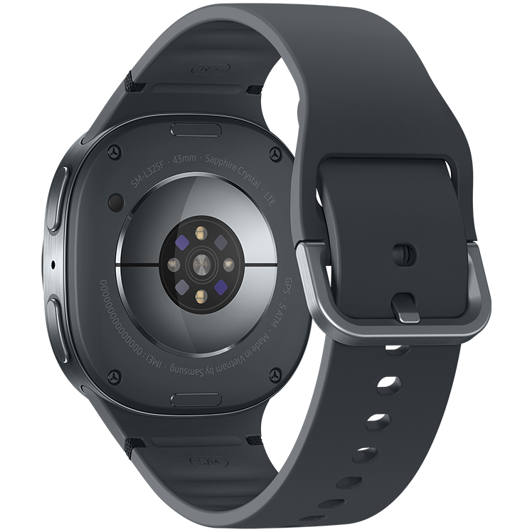 Galaxy Watch8 sedd från baksidan med pulssensor och sensorer synliga, med mörkgrått silikonarmband.