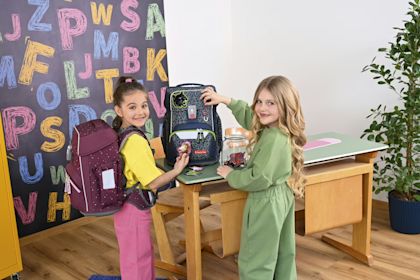 Two children at school with Southbag backpacks