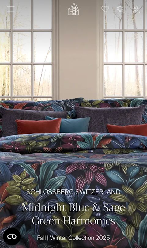 "Schlossberg Switzerland" Mobile homepage showing a bed in front of windows