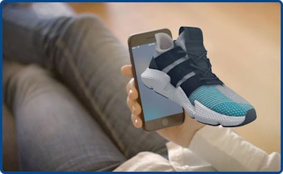 Picture spatial An AR example where a sneaker appears to emerge from a smartphone screen.