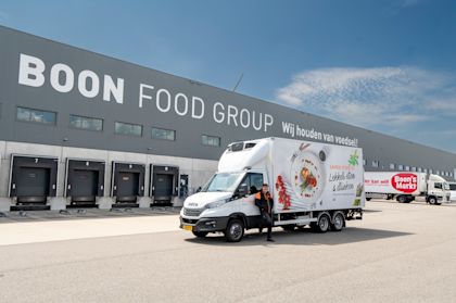 Distribution center of Boon Food Group with branded delivery truck positioned in front of the loading docks.