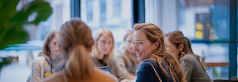 Header banner showing women in a discussion 