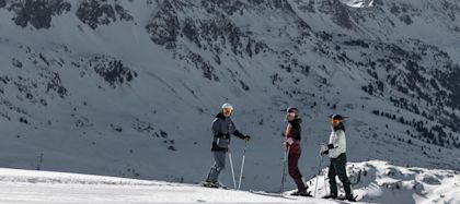 3 skiers on snowy mountains