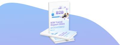 3D-Rendering eines Buches mit dem Titel "B2B Trends Report 2024" von Shopware. Das Cover enthält geschäftsbezogene Icons und ein Bild von zwei Personen, die sich unterhalten. Ein Buch steht aufrecht, das andere liegt flach auf einem blauen Hintergrund mit Farbverlauf.