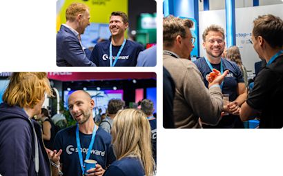 narrative-enterprise-level Alcuni dipendenti di Shopware chiacchierano allegramente con gli ospiti di una fiera.